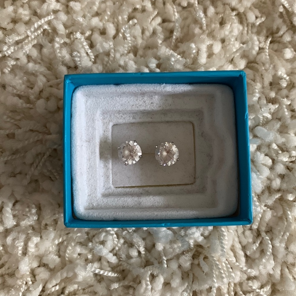 Sterling silver circular stud earrings.